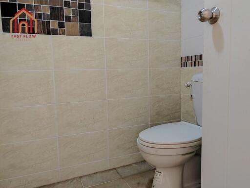 Bathroom with tiled walls and toilet