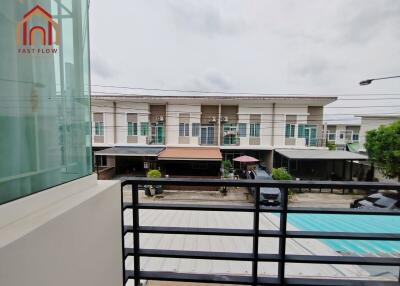 View from the balcony overlooking a row of modern townhouses