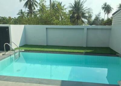 Outdoor swimming pool with grassy area