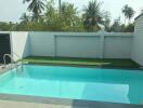 Outdoor swimming pool with grassy area