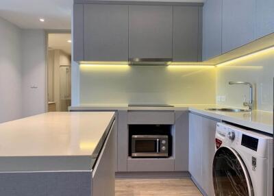 Modern kitchen with built-in appliances and under-cabinet lighting