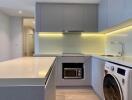 Modern kitchen with built-in appliances and under-cabinet lighting