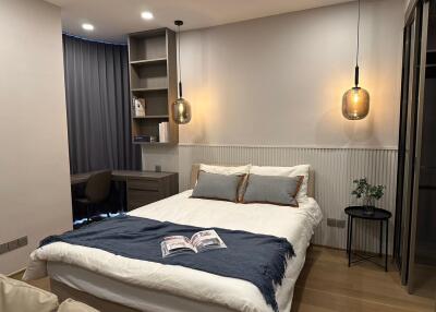 Modern bedroom with double bed and a study area