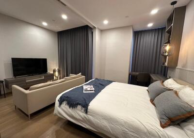 Modern Bedroom with Seating Area and TV
