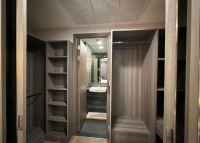 Spacious walk-in closet with wooden shelves and hanging space