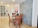 Modern dining area with wooden chairs and glass table