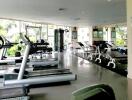 Gym with modern equipment and large windows for natural light