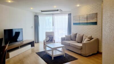 Modern living room with TV, sofa, and coffee table