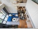 Modern living room with blue sofa and dining area, view from above