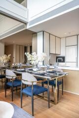 Modern dining room with blue chairs and a table set for dinner