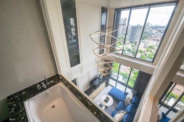 Aerial view of living room with large windows and city view