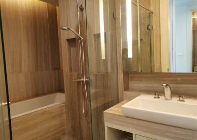 Modern bathroom with glass-enclosed shower and bathtub