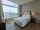 Bedroom with large window and city view