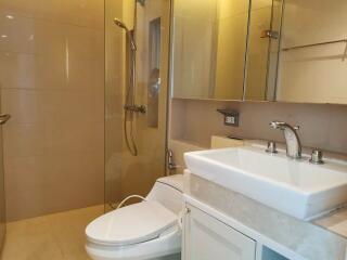 Modern bathroom with glass shower enclosure and white fixtures