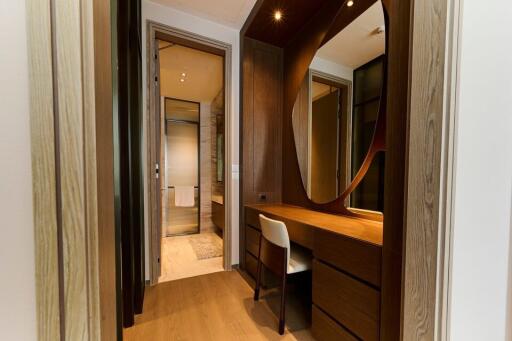 Bedroom vanity with wooden dresser and large mirror