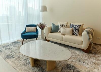 Modern living room with sofa, armchair, and coffee table