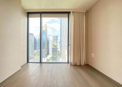 Spacious living room with large windows and city view