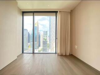 Spacious living room with large windows and city view