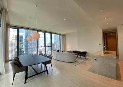 spacious and modern living area with a dining table and a city view