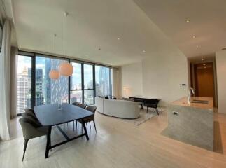 spacious and modern living area with a dining table and a city view