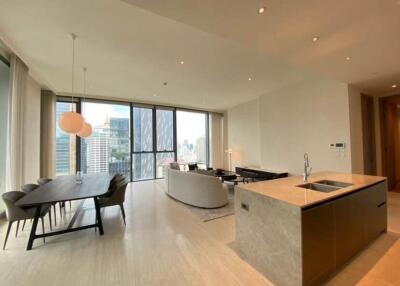 Spacious open-plan living room with large windows