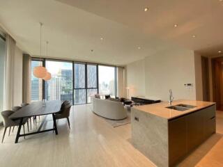 Spacious open-plan living room with large windows