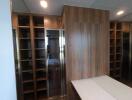 Spacious walk-in closet with wooden shelves and cabinets