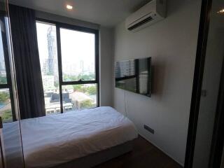 Modern bedroom with a large window, air conditioning, and a wall-mounted TV