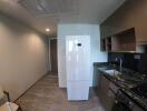 Modern kitchen with white refrigerator and granite countertop