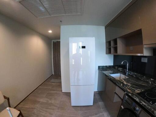 Modern kitchen with white refrigerator and granite countertop