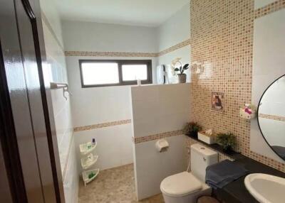 Modern bathroom with tiled walls and a built-in vanity