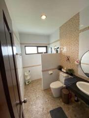 Modern bathroom with tiled walls and a built-in vanity