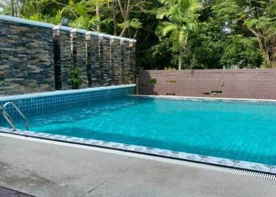 Outdoor swimming pool with surrounding greenery