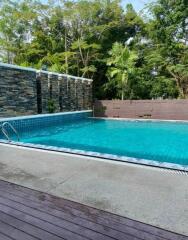 Outdoor swimming pool with surrounding greenery