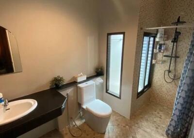 Bathroom with modern fixtures including a walk-in shower and a vanity