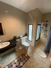 Bathroom with modern fixtures including a walk-in shower and a vanity