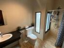 Bathroom with modern fixtures including a walk-in shower and a vanity