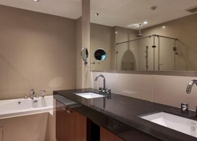 Modern bathroom with double sinks and bathtub