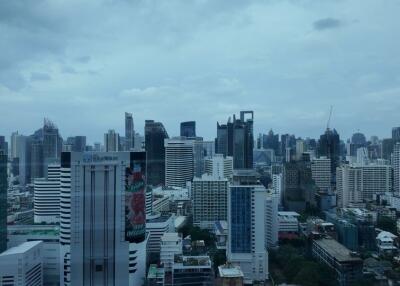 City skyline view with various buildings under a cloudy sky