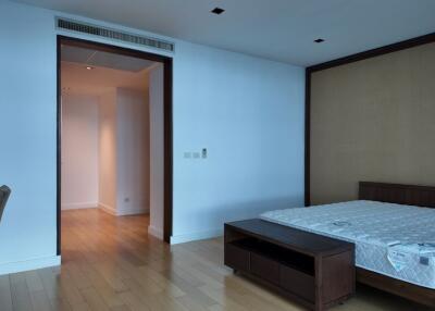 Bedroom with wooden flooring and a bed