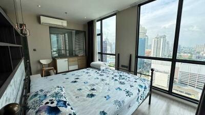 Modern bedroom with large windows and city view