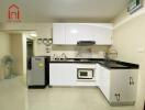 Modern kitchen with white cabinets and appliances