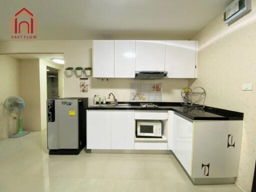 Modern kitchen with white cabinets and appliances