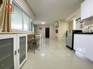 Modern kitchen area with appliances and dining space