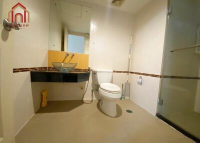 Modern bathroom with toilet, sink, and glass shower