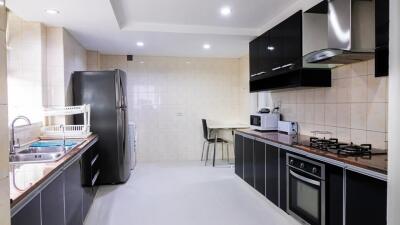 Modern kitchen with black cabinets and appliances