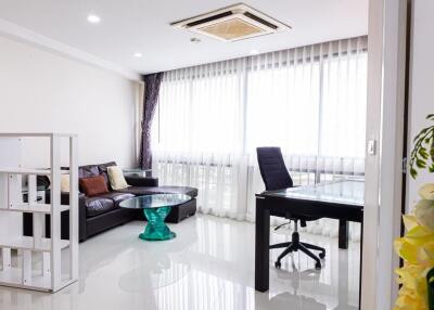 Modern living room with large windows and workspace