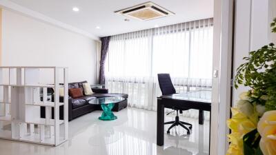 Modern living room with large windows and workspace