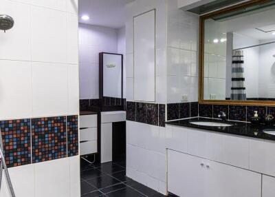 Modern bathroom with dual sinks and large mirror