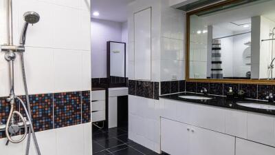 Modern bathroom with dual sinks and large mirror